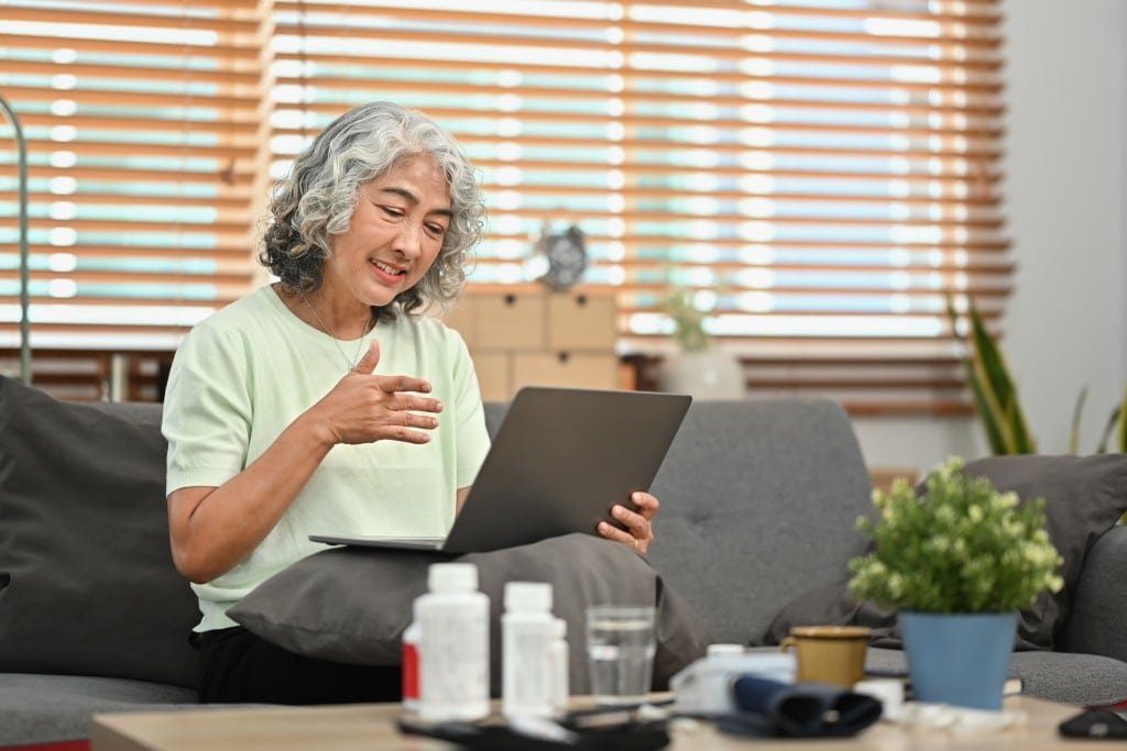 elderly-woman-sitting-on-couch-having-online-consu-2023-03-22-13-11-49-utc-1