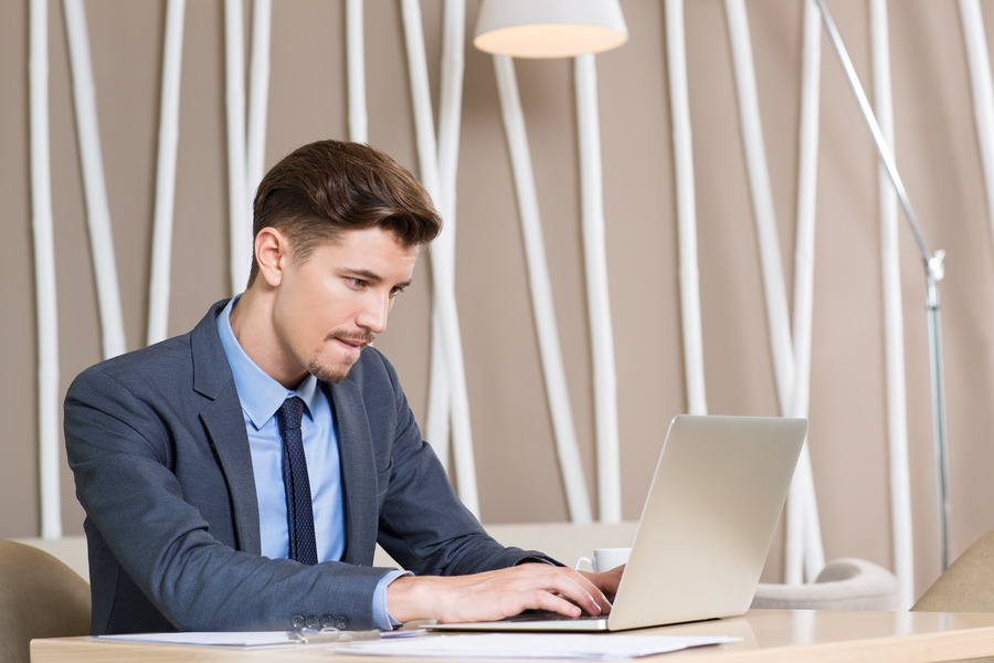 adult-businessman-working-hard-laptop-office-1-1
