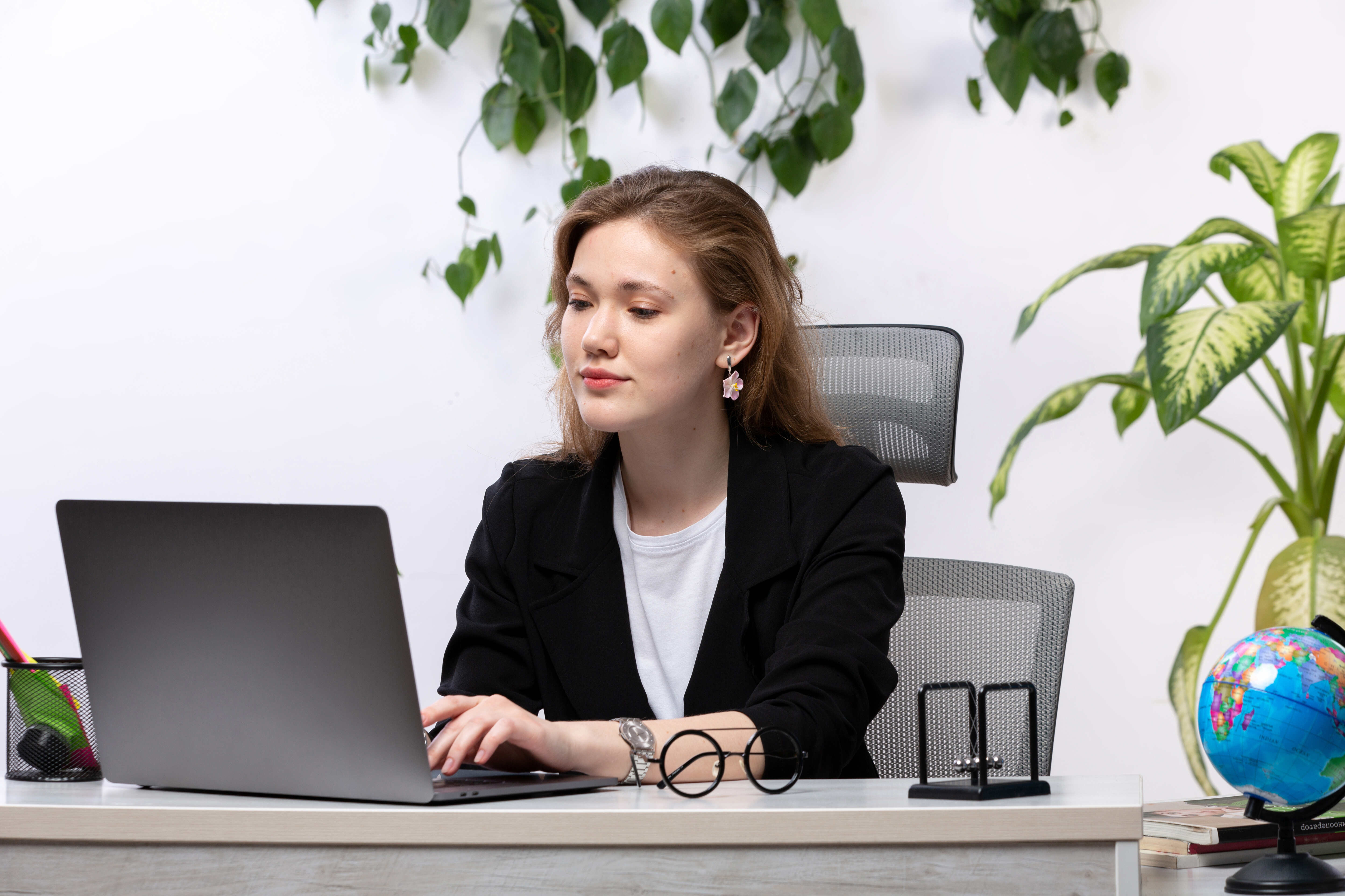 front-view-young-beautiful-lady-white-shirt-black-jacket-working-with-documents-using-her-laptop-front-table-with-leaves-hanging-1-1