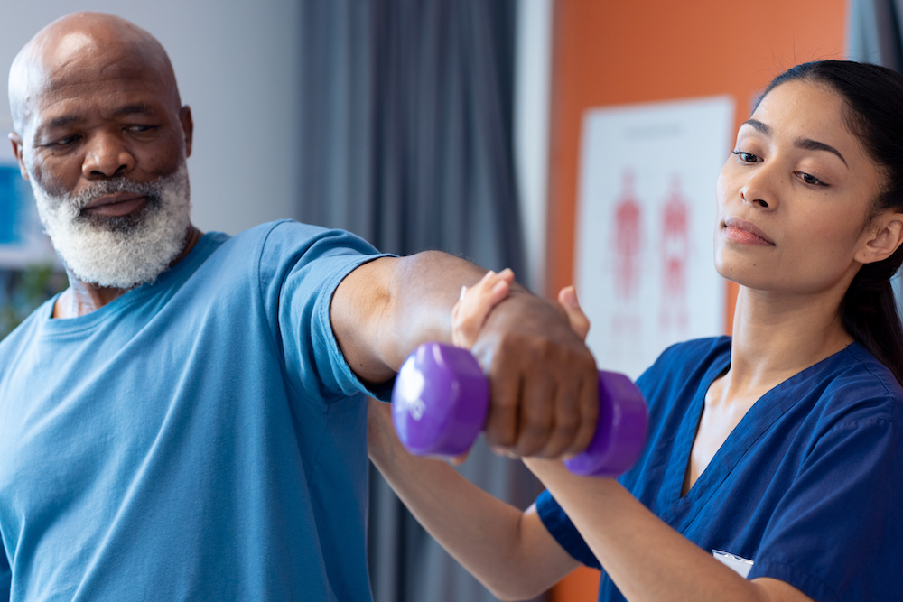 man-exercising-with-purple-weights-assisted-by-pro-2026-03-25-09-05-42-utc