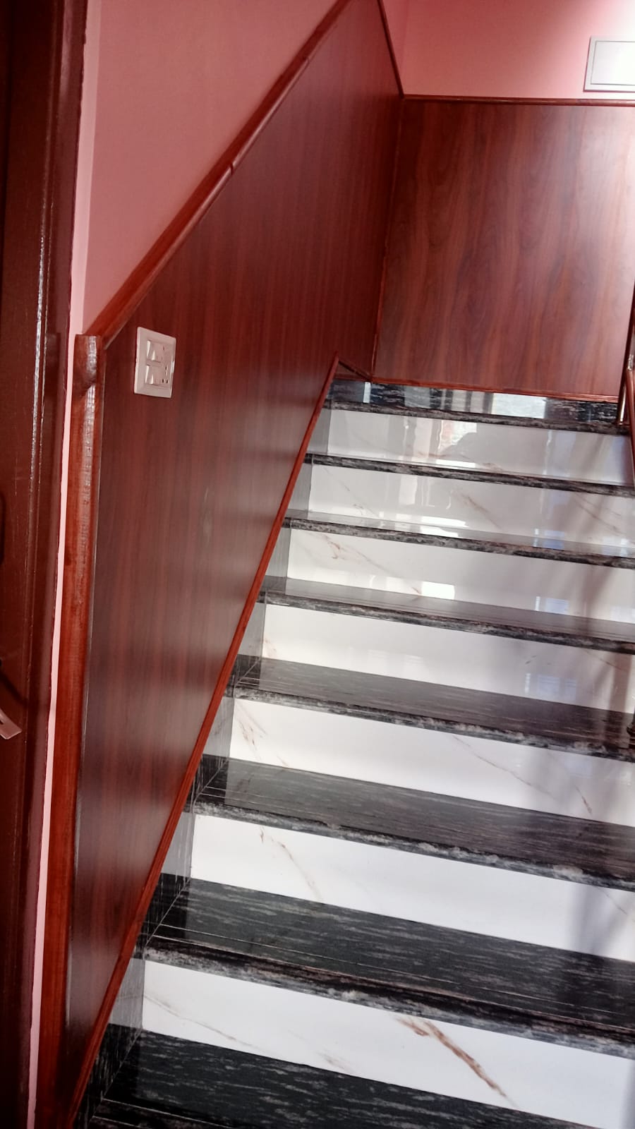 custom-wooden-staircase-wall-panels-and-marble-stairs.jpg
