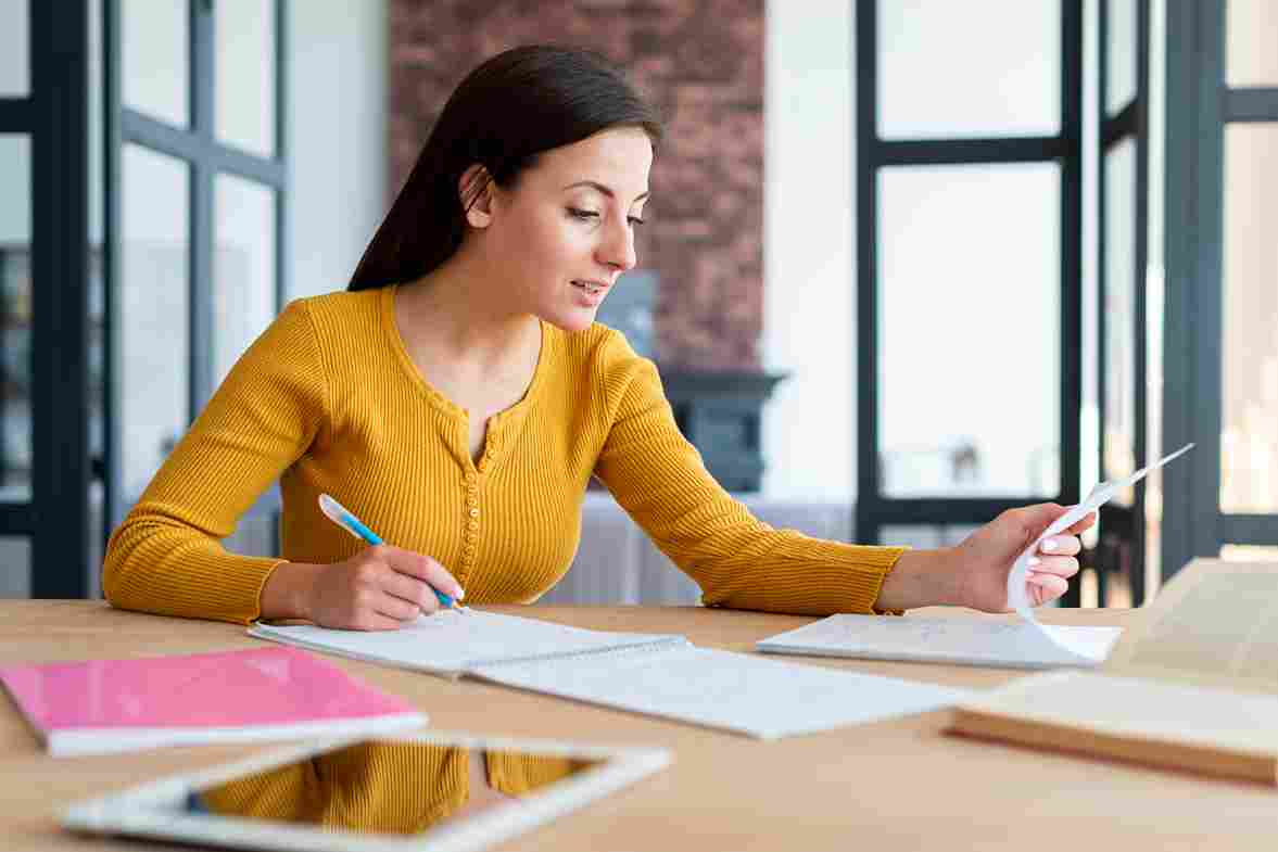 woman-working-checking-her-notes_11zon-1