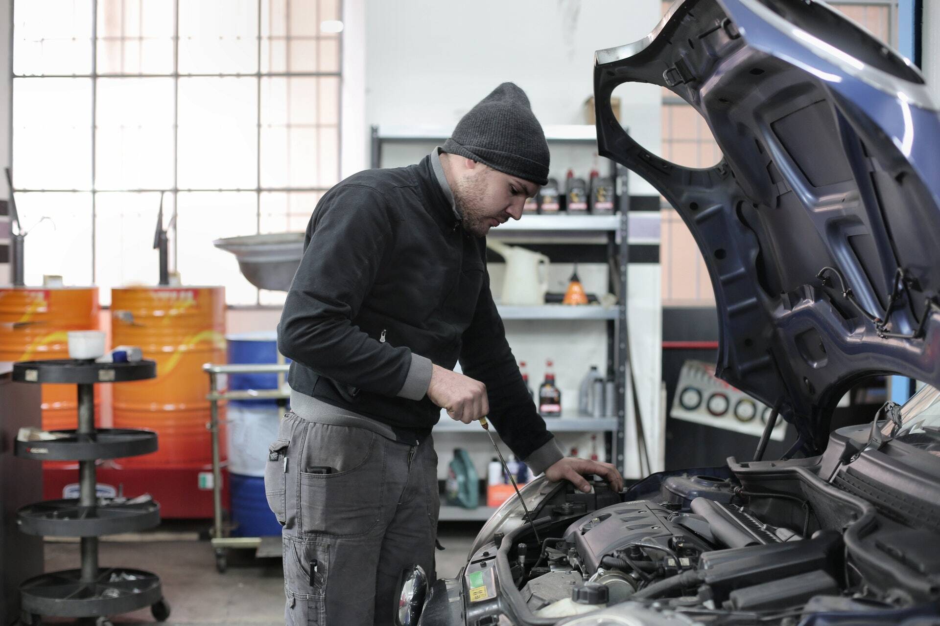 photo-of-man-inspecting-car-engine-3807517-1