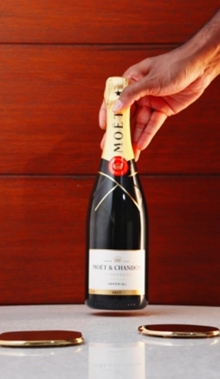 hand-holding-moet-chandon-imperial-brut-champagne-bottle—mont-laurent