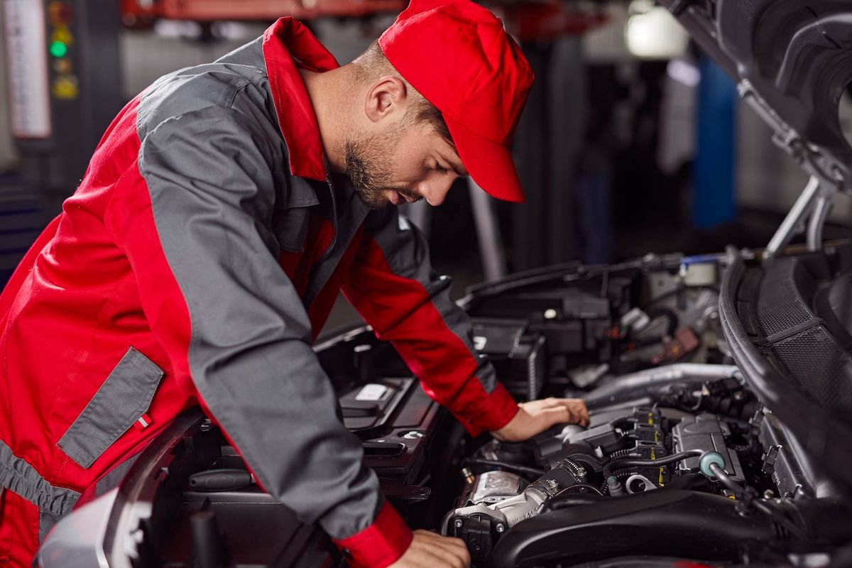 mechanic-checking-car-engine-in-workshop-2026-01-09-00-31-48-utc